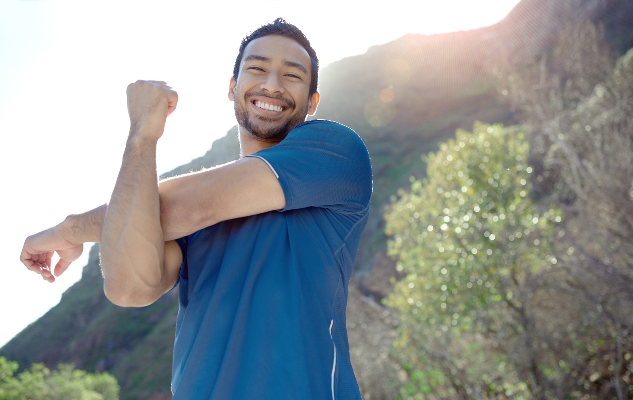 fitness-portrait-stretching-with-man-runner-outdoor-mountains-cardio-endurance-workout-exercise-sports-smile-with-young-male-athlete-getting-ready-run-nature
